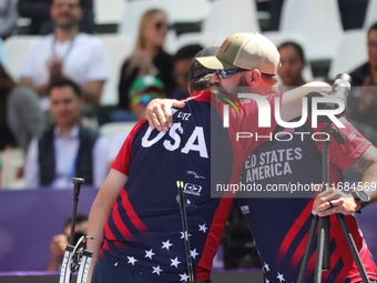 James Lutz of the United States competes against Mathias Fullerton of Denmark (not in picture) during the men's compound gold medal match on...