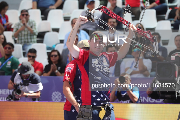 James Lutz of the United States competes against Mathias Fullerton of Denmark (not in picture) during the men's compound gold medal match on...