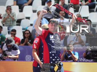 James Lutz of the United States competes against Mathias Fullerton of Denmark (not in picture) during the men's compound gold medal match on...