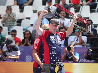 James Lutz of the United States competes against Mathias Fullerton of Denmark (not in picture) during the men's compound gold medal match on...