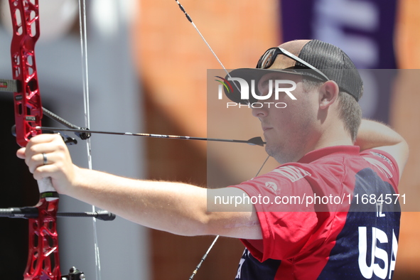 James Lutz of the United States competes against Mathias Fullerton of Denmark (not in picture) during the men's compound gold medal match on...