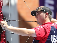 James Lutz of the United States competes against Mathias Fullerton of Denmark (not in picture) during the men's compound gold medal match on...