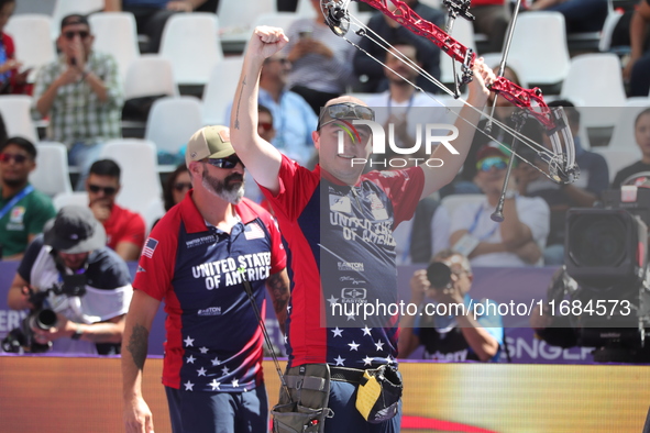 James Lutz of the United States competes against Mathias Fullerton of Denmark (not in picture) during the men's compound gold medal match on...