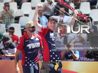 James Lutz of the United States competes against Mathias Fullerton of Denmark (not in picture) during the men's compound gold medal match on...