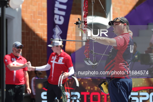 James Lutz of the United States competes against Mathias Fullerton of Denmark (not in picture) during the men's compound gold medal match on...