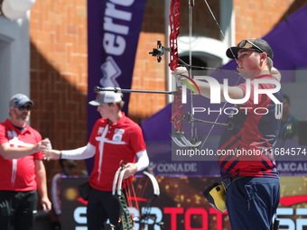 James Lutz of the United States competes against Mathias Fullerton of Denmark (not in picture) during the men's compound gold medal match on...