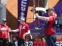 James Lutz of the United States competes against Mathias Fullerton of Denmark (not in picture) during the men's compound gold medal match on...