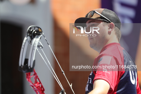 James Lutz of the United States competes against Mathias Fullerton of Denmark (not in picture) during the men's compound gold medal match on...