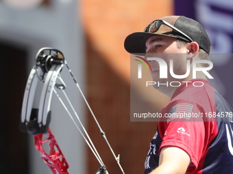 James Lutz of the United States competes against Mathias Fullerton of Denmark (not in picture) during the men's compound gold medal match on...