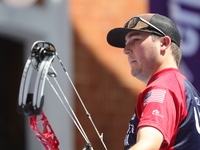 James Lutz of the United States competes against Mathias Fullerton of Denmark (not in picture) during the men's compound gold medal match on...