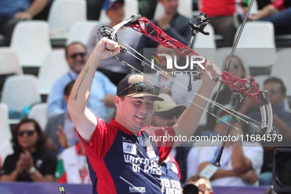 James Lutz of the United States competes against Mathias Fullerton of Denmark (not in picture) during the men's compound gold medal match on...