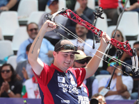 James Lutz of the United States competes against Mathias Fullerton of Denmark (not in picture) during the men's compound gold medal match on...