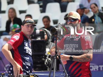 James Lutz of the United States competes against Mathias Fullerton of Denmark (not in picture) during the men's compound gold medal match on...