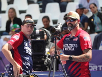 James Lutz of the United States competes against Mathias Fullerton of Denmark (not in picture) during the men's compound gold medal match on...