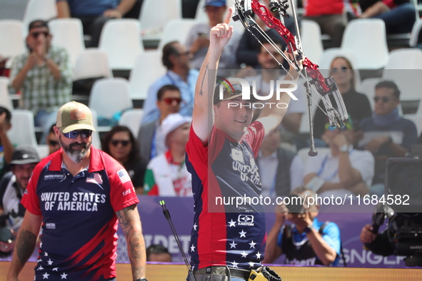 James Lutz of the United States competes against Mathias Fullerton of Denmark (not in picture) during the men's compound gold medal match on...