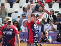 James Lutz of the United States competes against Mathias Fullerton of Denmark (not in picture) during the men's compound gold medal match on...