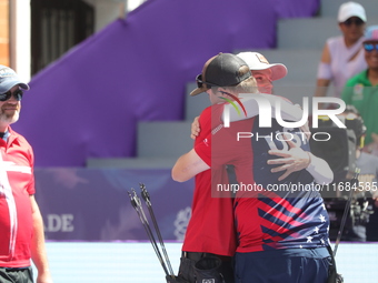 James Lutz of the United States and Mathias Fullerton of Denmark compete during the men's compound gold medal match on the second day of the...