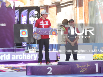 Second place Mathias Fullerton of Denmark and gold medalist James Lutz of the United States stand during the medal ceremony after the men's...