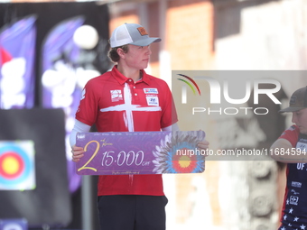 Silver medalist Mathias Fullerton of Denmark participates in the medal ceremony after the men's compound final match on the second day of th...