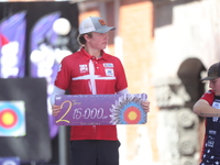 Silver medalist Mathias Fullerton of Denmark participates in the medal ceremony after the men's compound final match on the second day of th...