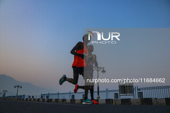 Participants run during the Kashmir Marathon on the banks of Dal Lake in Srinagar, Jammu and Kashmir, on October 20, 2024. Kashmir hosts its...