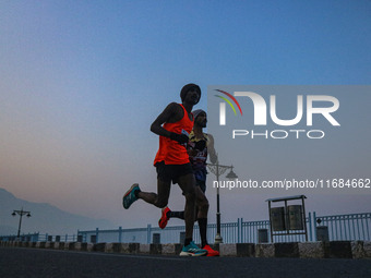 Participants run during the Kashmir Marathon on the banks of Dal Lake in Srinagar, Jammu and Kashmir, on October 20, 2024. Kashmir hosts its...