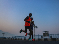 Participants run during the Kashmir Marathon on the banks of Dal Lake in Srinagar, Jammu and Kashmir, on October 20, 2024. Kashmir hosts its...