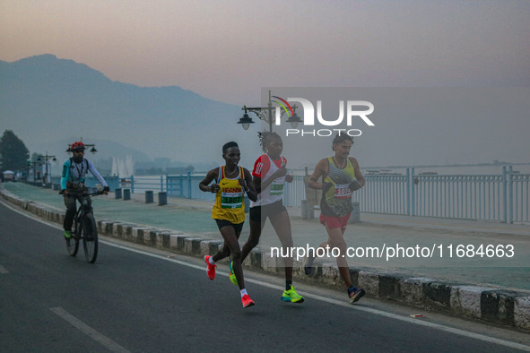 Participants run during the Kashmir Marathon on the banks of Dal Lake in Srinagar, Jammu and Kashmir, on October 20, 2024. Kashmir hosts its...