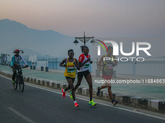 Participants run during the Kashmir Marathon on the banks of Dal Lake in Srinagar, Jammu and Kashmir, on October 20, 2024. Kashmir hosts its...