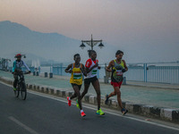 Participants run during the Kashmir Marathon on the banks of Dal Lake in Srinagar, Jammu and Kashmir, on October 20, 2024. Kashmir hosts its...