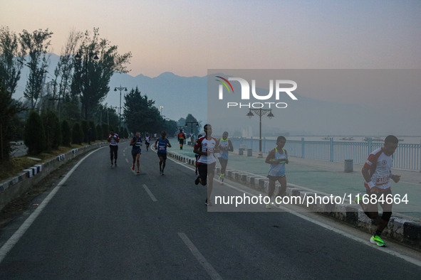 Participants run during the Kashmir Marathon on the banks of Dal Lake in Srinagar, Jammu and Kashmir, on October 20, 2024. Kashmir hosts its...