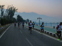 Participants run during the Kashmir Marathon on the banks of Dal Lake in Srinagar, Jammu and Kashmir, on October 20, 2024. Kashmir hosts its...