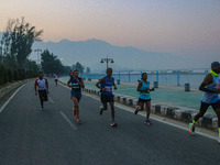 Participants run during the Kashmir Marathon on the banks of Dal Lake in Srinagar, Jammu and Kashmir, on October 20, 2024. Kashmir hosts its...