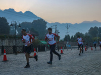 Participants run during the Kashmir Marathon on the banks of Dal Lake in Srinagar, Jammu and Kashmir, on October 20, 2024. Kashmir hosts its...