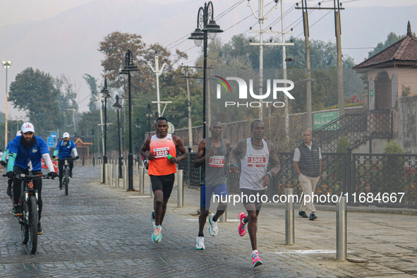 Participants run during the Kashmir Marathon on the banks of Dal Lake in Srinagar, Jammu and Kashmir, on October 20, 2024. Kashmir hosts its...