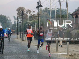 Participants run during the Kashmir Marathon on the banks of Dal Lake in Srinagar, Jammu and Kashmir, on October 20, 2024. Kashmir hosts its...