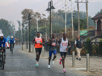 Participants run during the Kashmir Marathon on the banks of Dal Lake in Srinagar, Jammu and Kashmir, on October 20, 2024. Kashmir hosts its...