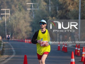 A participant runs during the Kashmir Marathon on the banks of Dal Lake in Srinagar, Jammu and Kashmir, on October 20, 2024. Kashmir hosts i...