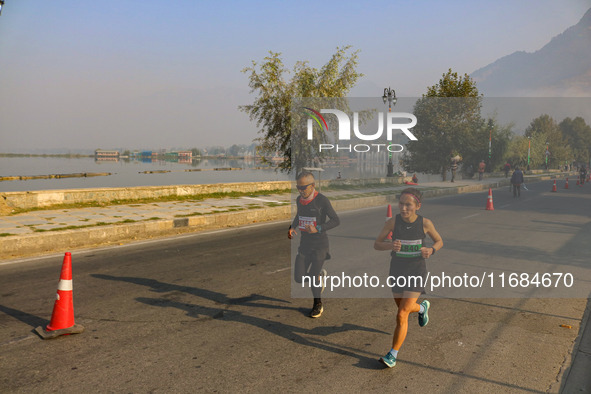 Participants run during the Kashmir Marathon on the banks of Dal Lake in Srinagar, Jammu and Kashmir, on October 20, 2024. Kashmir hosts its...