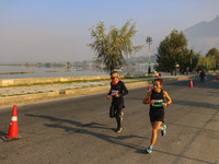 Participants run during the Kashmir Marathon on the banks of Dal Lake in Srinagar, Jammu and Kashmir, on October 20, 2024. Kashmir hosts its...