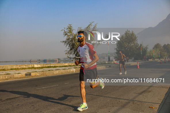 Participants run during the Kashmir Marathon on the banks of Dal Lake in Srinagar, Jammu and Kashmir, on October 20, 2024. Kashmir hosts its...