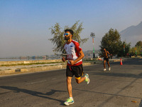 Participants run during the Kashmir Marathon on the banks of Dal Lake in Srinagar, Jammu and Kashmir, on October 20, 2024. Kashmir hosts its...