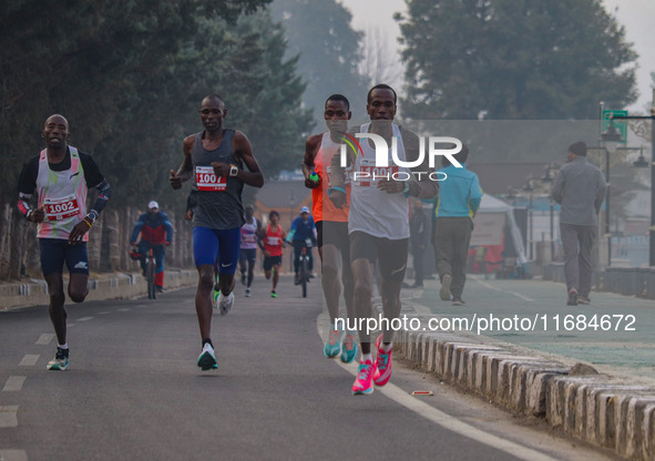 Participants run during the Kashmir Marathon on the banks of Dal Lake in Srinagar, Jammu and Kashmir, on October 20, 2024. Kashmir hosts its...