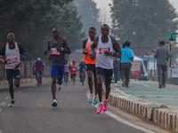 Participants run during the Kashmir Marathon on the banks of Dal Lake in Srinagar, Jammu and Kashmir, on October 20, 2024. Kashmir hosts its...