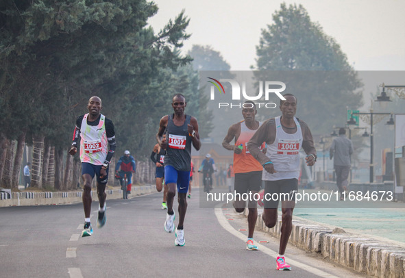 Participants run during the Kashmir Marathon on the banks of Dal Lake in Srinagar, Jammu and Kashmir, on October 20, 2024. Kashmir hosts its...