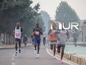 Participants run during the Kashmir Marathon on the banks of Dal Lake in Srinagar, Jammu and Kashmir, on October 20, 2024. Kashmir hosts its...