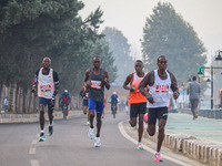 Participants run during the Kashmir Marathon on the banks of Dal Lake in Srinagar, Jammu and Kashmir, on October 20, 2024. Kashmir hosts its...