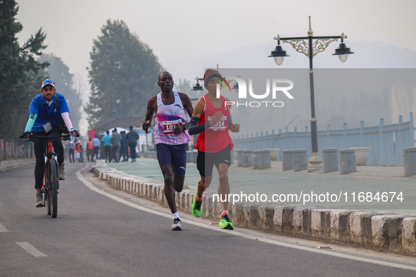 Participants run during the Kashmir Marathon on the banks of Dal Lake in Srinagar, Jammu and Kashmir, on October 20, 2024. Kashmir hosts its...