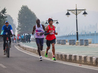 Participants run during the Kashmir Marathon on the banks of Dal Lake in Srinagar, Jammu and Kashmir, on October 20, 2024. Kashmir hosts its...