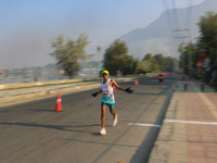 A participant runs during the Kashmir Marathon on the banks of Dal Lake in Srinagar, Jammu and Kashmir, on October 20, 2024. Kashmir hosts i...